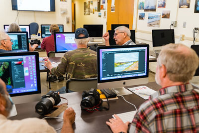 Veterans using computers connected with Canon cameras and printers