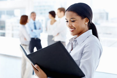 Business Woman looking through folder