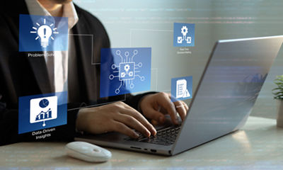 Image of a man working on a laptop computer