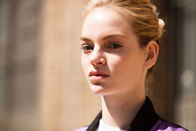 Portrait of fair-skinned blonde model with her hair pulled back and hard light reflectin off her face