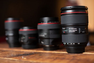 Lineup of four lenses on a wooden surface