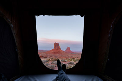 The view from inside a cave looking over a canyon