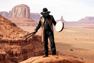 Picture of a Person Holding a Tamborine in the Desert
