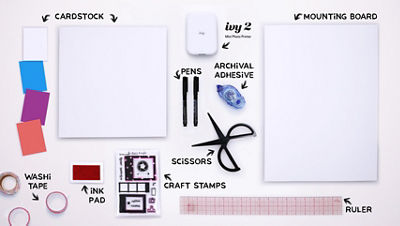 Overhead layout of labeled supplies for the project, including cardstock, mounting board, scissors, pens, adhesive, craft stamps, washi tape, ruler, and the Canon Ivy 2 Mini Photo Printer.