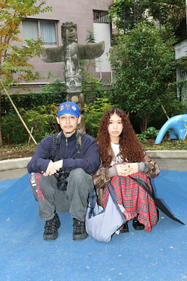 People Sitting with a Park Scene Behind Them