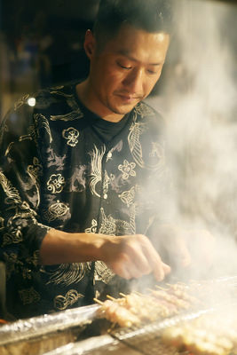 Person Cooking Skewers