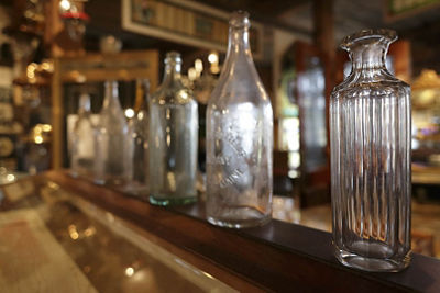 Different Glass Containers Lined Up at a Bar