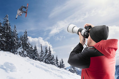 Person Using EOS R Camera to take a Picture of Snowboarder