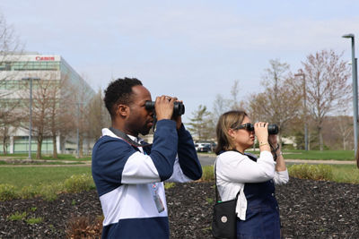 Canon Employees Using Binoculars