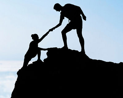 man helping woman to climb up