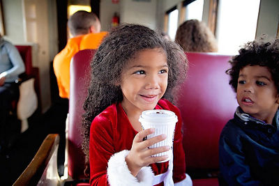 Child on a Train Drinking a Hot Beverage