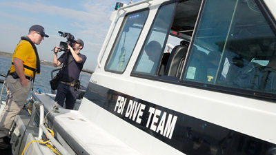 Person Using Canon Cinema Camera to Film Person on a Boat