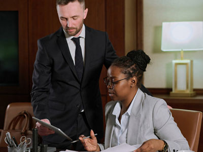 man and woman looking at a tablet in a law office
