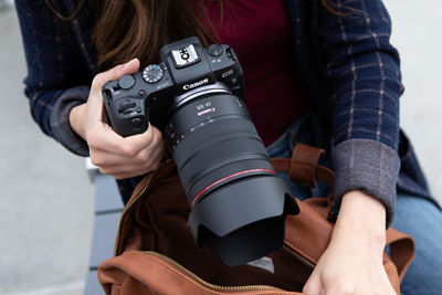 A close-up of a person holding a camera