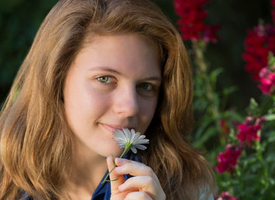 Girl smelling flower