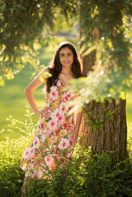 Girl posing next to tree