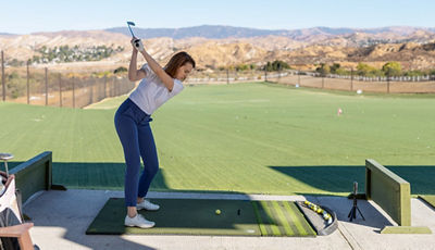 Person Swinging Golf Club