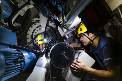 People Working on a Machine