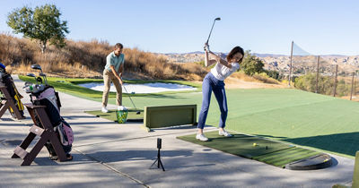 People Practicing Golf at the Driving Range