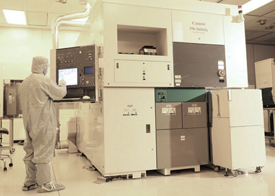 Person in hazmat suit working on FPA-5500iZa Stepper