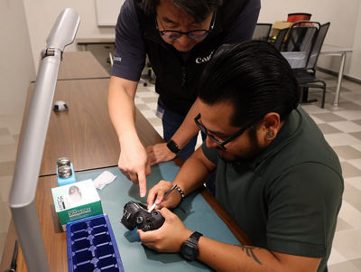Person Teaching How to Fix a Camera