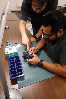 Person Teaching How to Fix a Camera