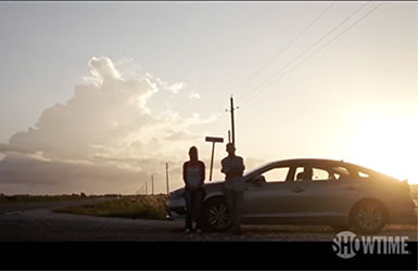 Two People in Front of a Car