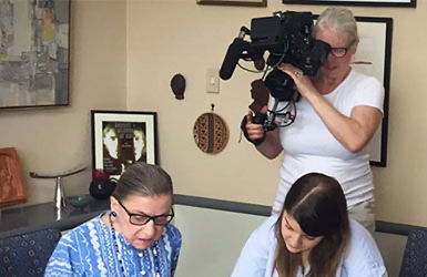 Person Using Canon Cinema Camera to Film Two People Talking