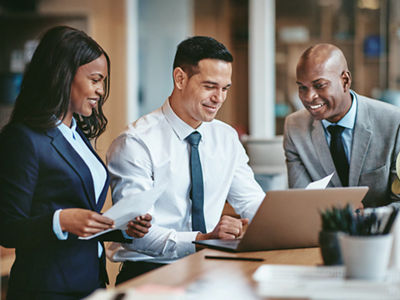 office workers looking at a laptop computer