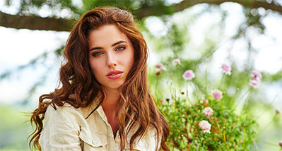Picture of woman in front of flowers