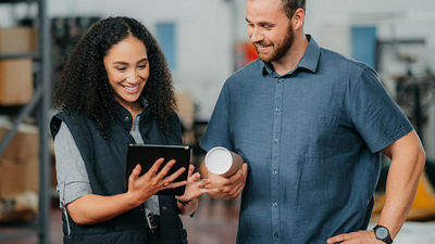 Image of a man and woman looking at a tablet