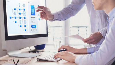 Image of two men looking at a computer screen