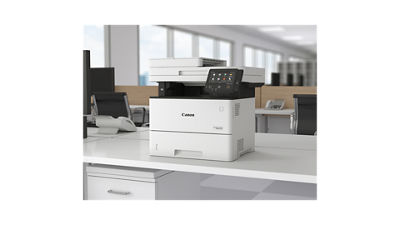 A Canon printer on an office desk.
