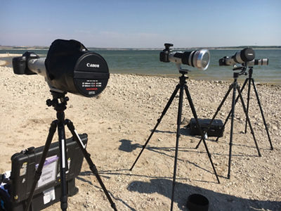 Canon bodies and lenses on tripods