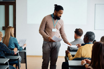 Teacher Handing Out Papers