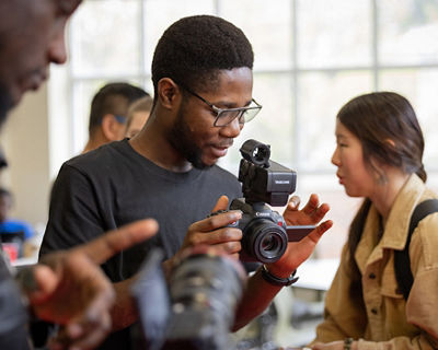 student holding a camera
