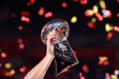 Football Player Carrying the Winning Trophy