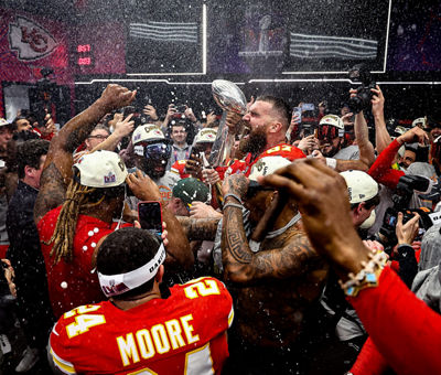 Football Players Celebrating with the Winning Trophy