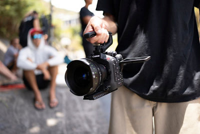 Person Hold EOS C80 by Handle