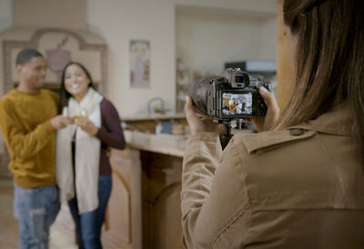 Lady taking picture of a couple