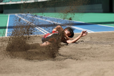 Athlete Sliding in the Sand