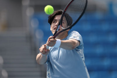 Tennis Player Hitting Tennis Ball with Racket