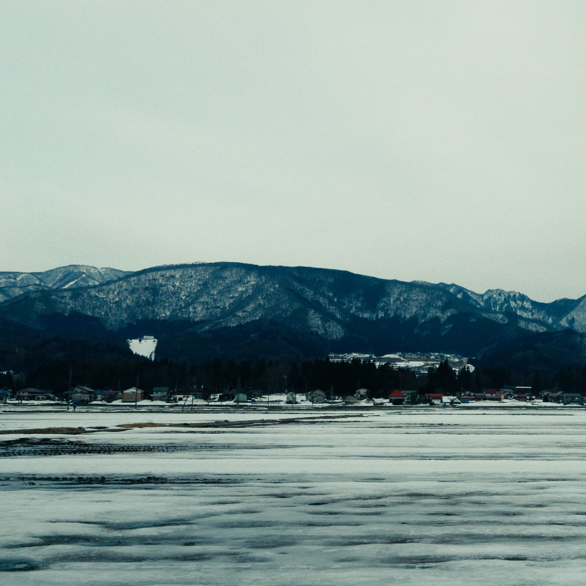 Body of Water with Mountain Range in the Background