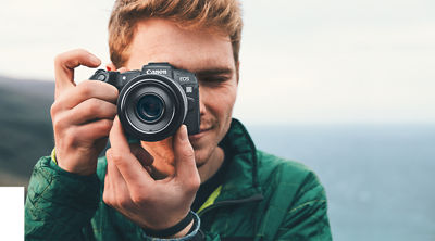 Young man taking picture with a EOS R camera