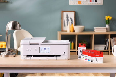 Printer on a Desk Next to Ink Boxes