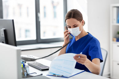 Healthcare provider on phone at desk