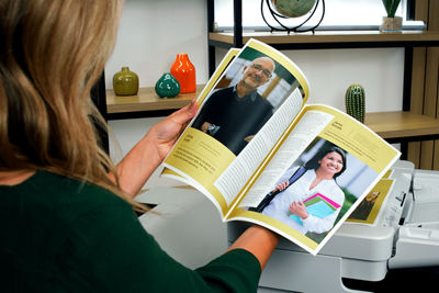 Woman looking over a printed brochure