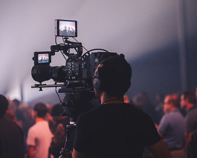 man with camera filming a house of worship event