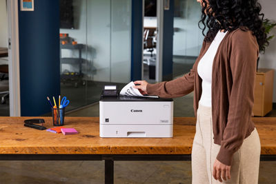 Person Retriving Printed Papers