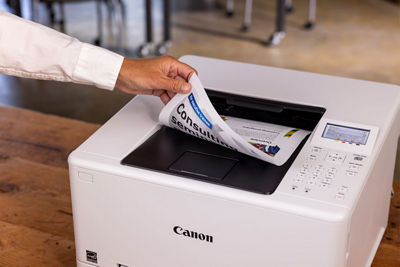 Person Retriving Printed Papers